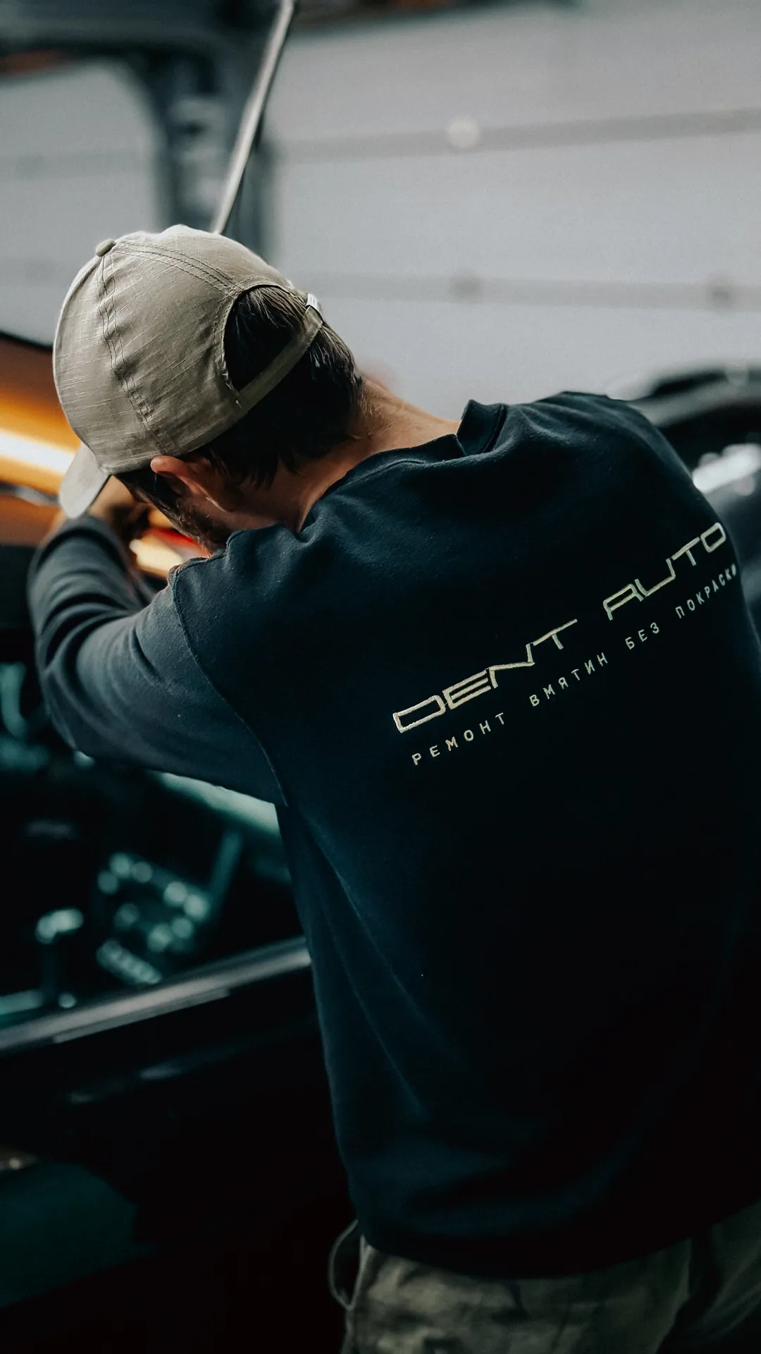 Мастер Dent Auto за работой в фирменной одежде